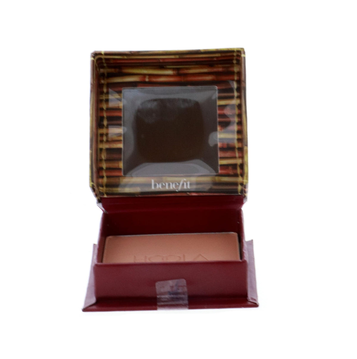 Benefit Hoola compact on vanity next to mirror illustrating travel-ready convenience