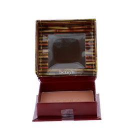 Benefit Hoola compact on vanity next to mirror illustrating travel-ready convenience