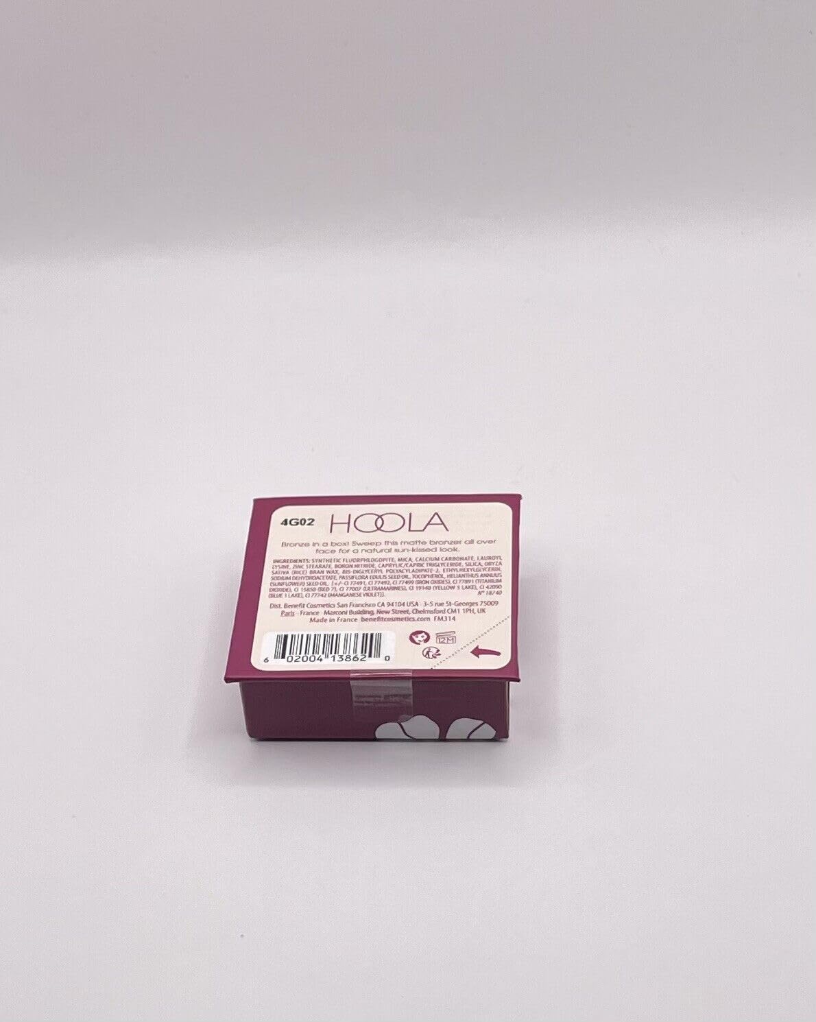 Benefit Hoola Mini beside travel items illustrating compact packing benefit