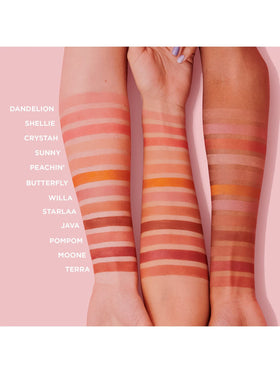 Benefit Shellie on vanity table styled for daily routine adding polished cheek color