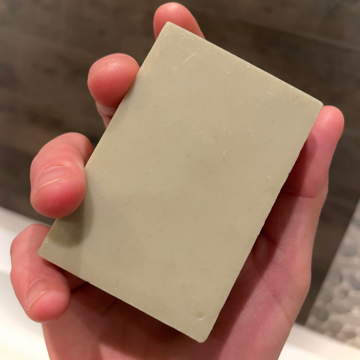 Big Crazy Buffalo soap in hand for scale showing compact two‑bar set and travel convenience