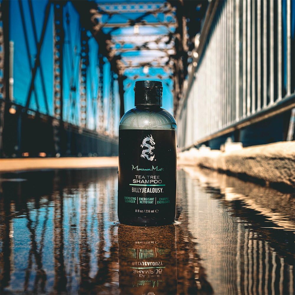 Billy Jealousy 8 oz bottle in hand for scale to show travel-friendly size advantage