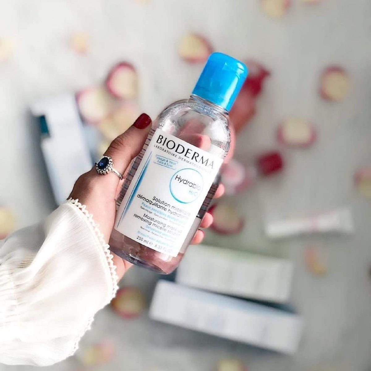 Bioderma in hand for scale showing large one-liter economical size
