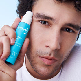 Bioderma travel size next to coin showing portable skincare convenience