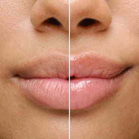 BIOSSANCE lip balm next to a finger showing compact size for on-the-go hydration