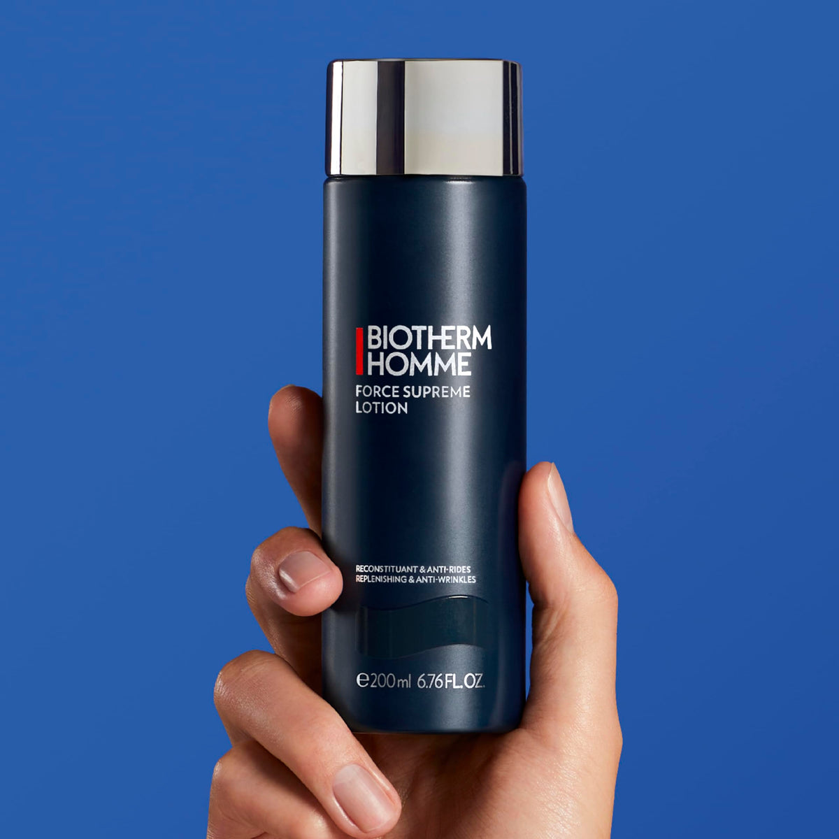Biotherm Force Supreme in hand displaying 6.8 fl oz scale and portability