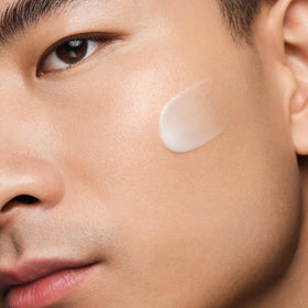 Lifestyle image of man applying Biotherm serum in morning routine for firmer-looking skin