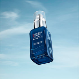 Biotherm bottle next to coin to show 2 fl oz scale and travel-friendly convenience