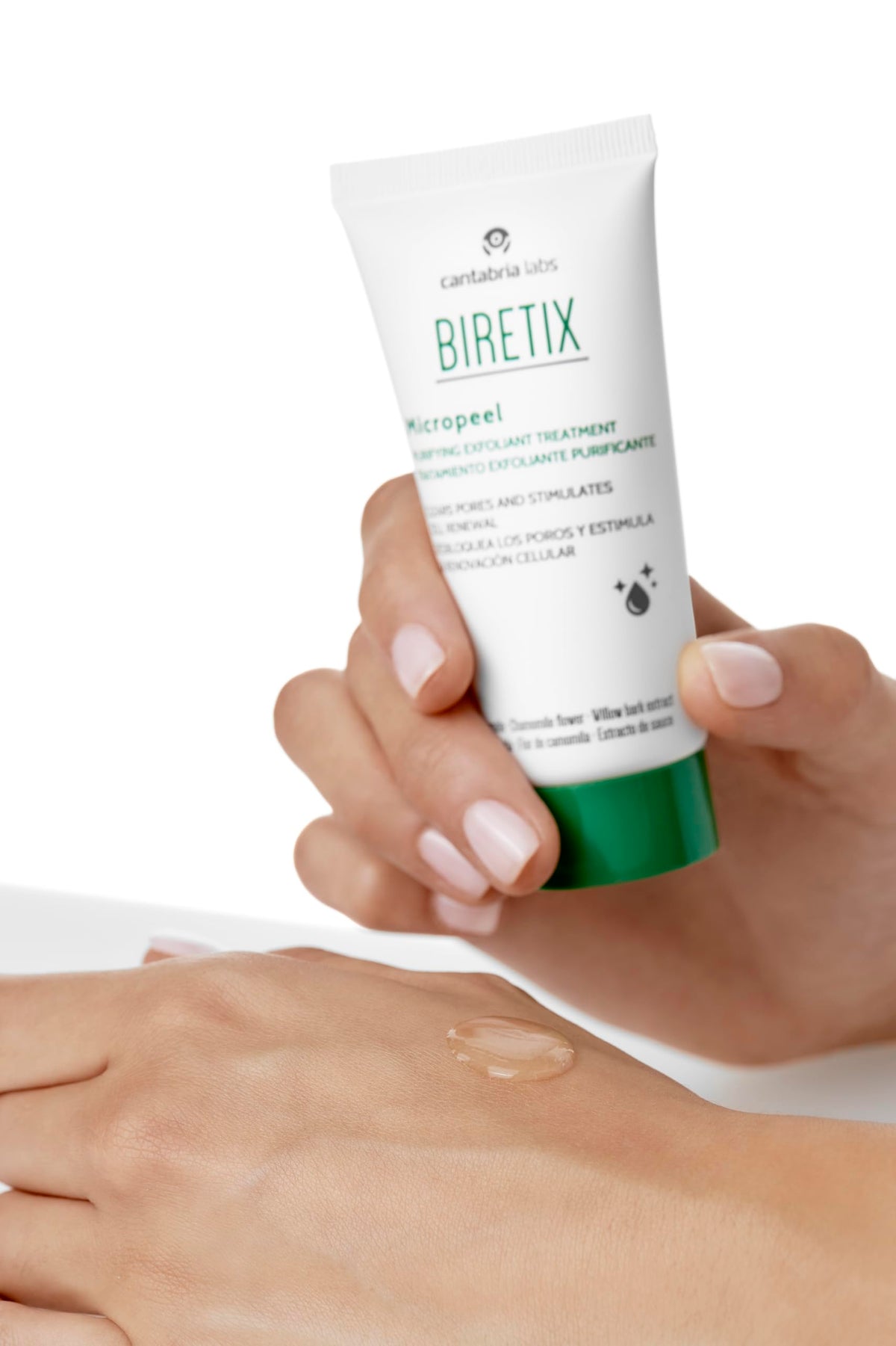Biretix bottle next to hand and box for scale, clear size view for dosing and travel convenience