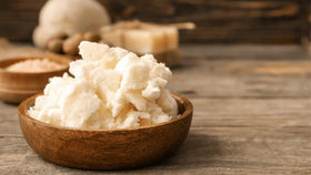 Bless International hand applying shea butter to skin for instant hydration benefit
