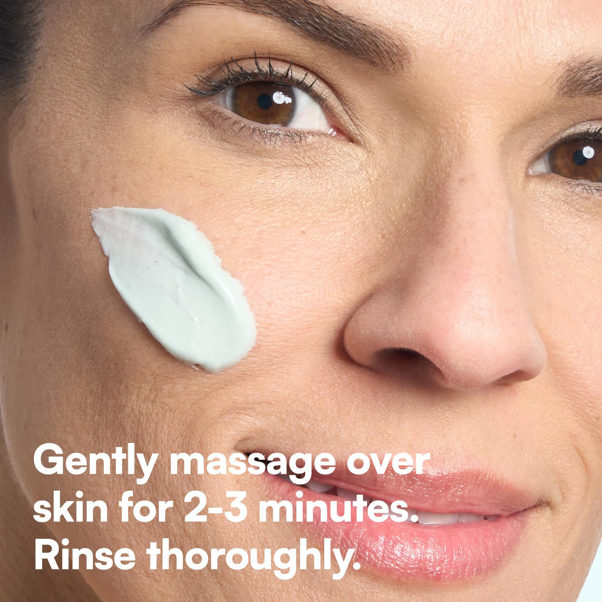 Bliss applying scrub to face in bathroom demonstrating gentle exfoliation