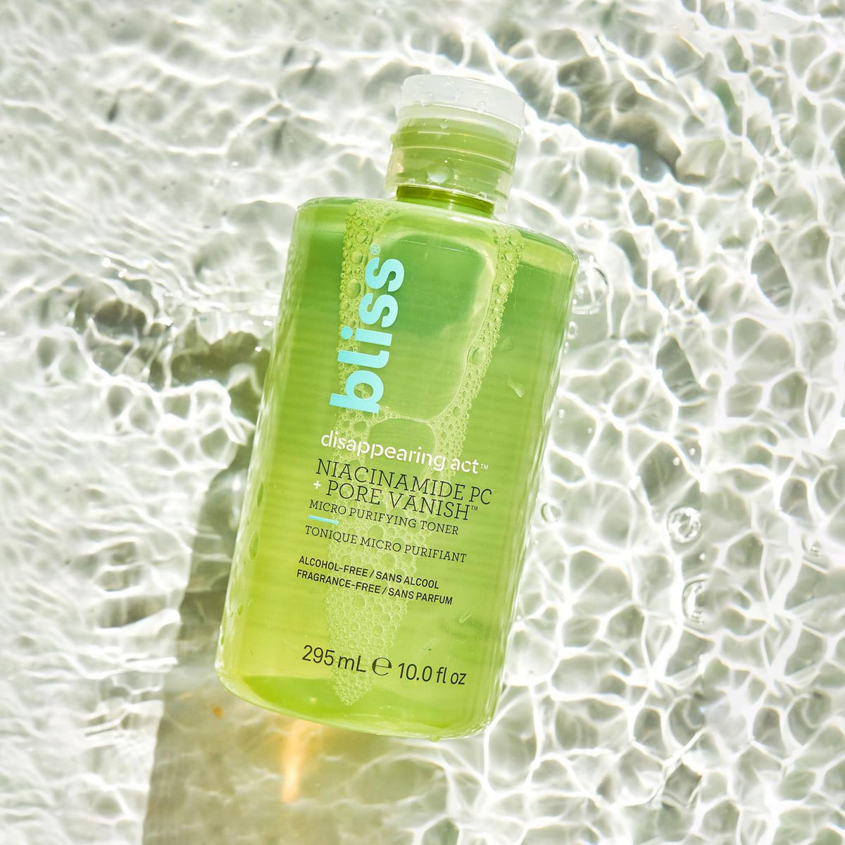 Bliss 10 fl oz bottle held in hand for size and scale reference