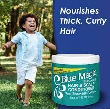 Applying Blue Magic conditioner to hair with fingers for hydration and control