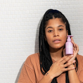 Blume Daydreamer bottle with water drops to show hydrating, non-stripping formula benefit