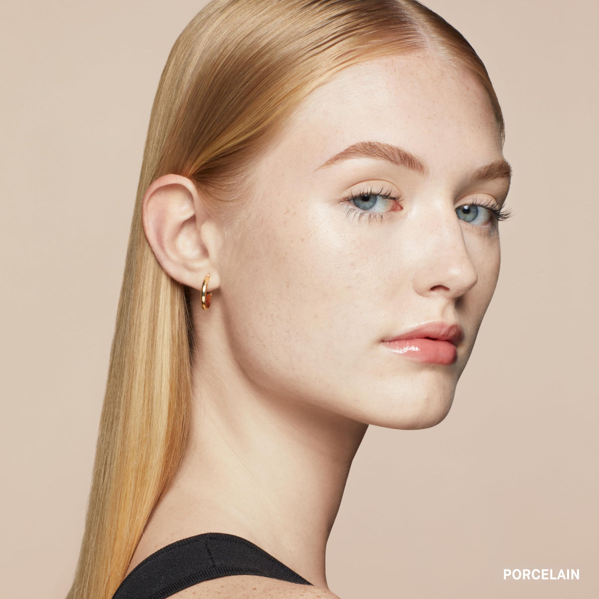 Bobbi Brown applying stick under eye demonstrating quick coverage benefit