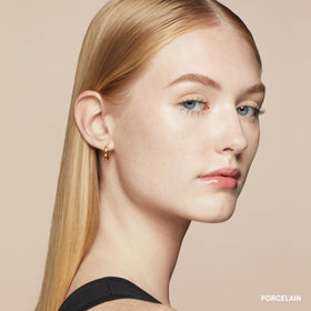 Bobbi Brown applying stick under eye demonstrating quick coverage benefit