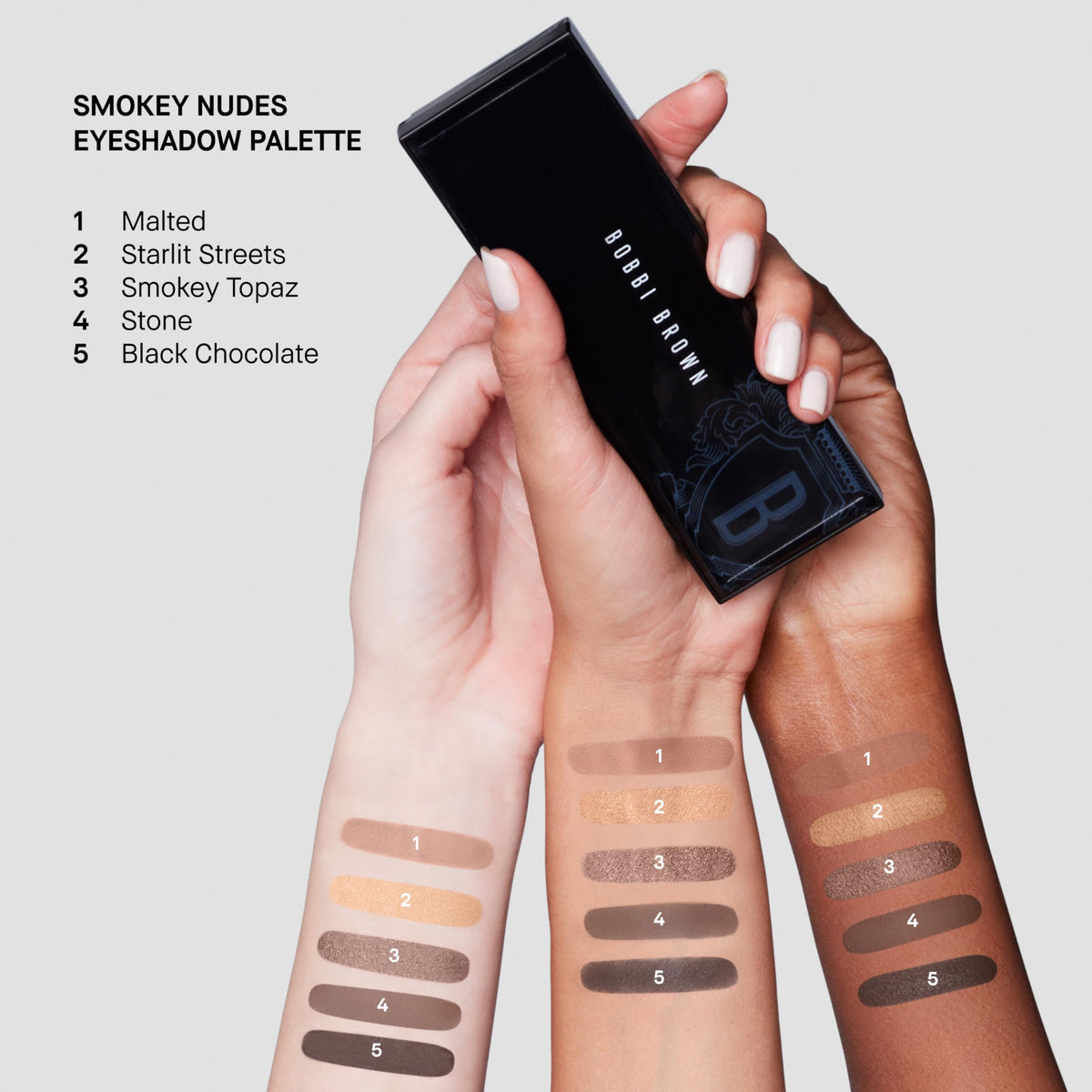 Bobbi Brown brush applying metallic shade to lid for luminous highlight