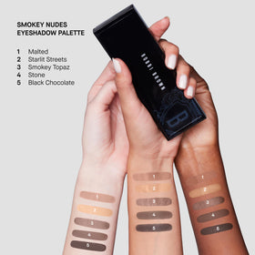 Bobbi Brown brush applying metallic shade to lid for luminous highlight