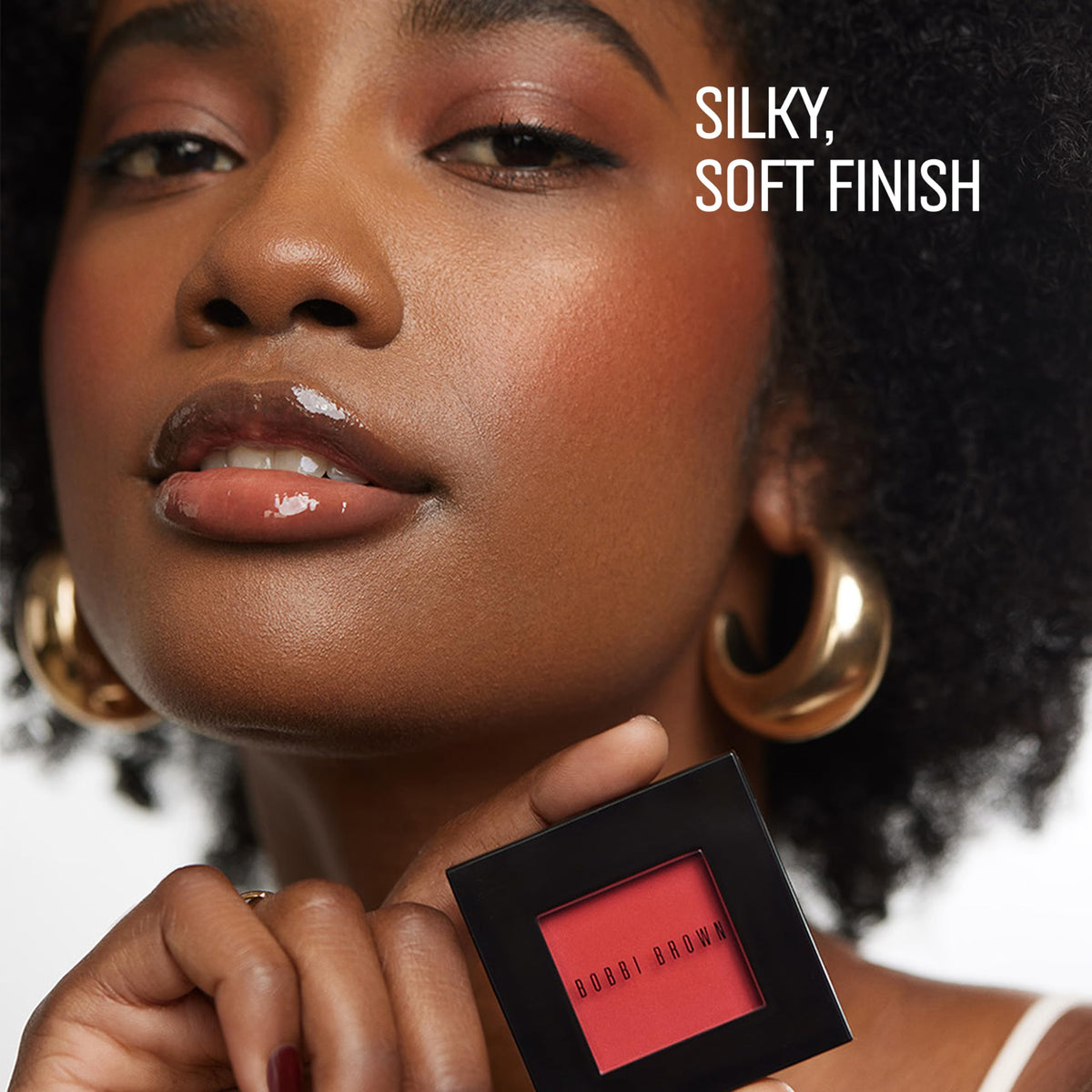Bobbi Brown blush on model cheek demonstrating natural-looking flush