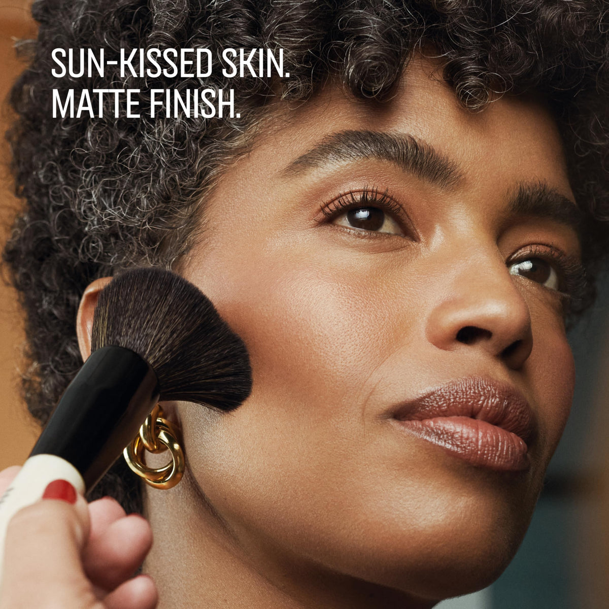 Bobbi Brown bronzing powder swatches on arm demonstrate shade range benefit