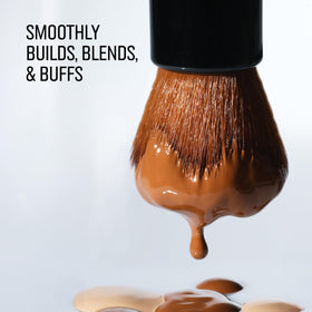 Bobbi Brown brush applying foundation near nose, demonstrating precise coverage in use