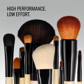 Bobbi Brown brush held in hand to show compact size and control for detailed work
