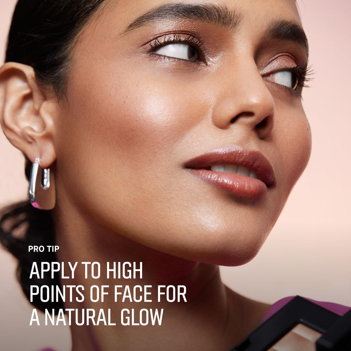 Bobbi Brown damp brush picking up powder for intensified, dewy glow