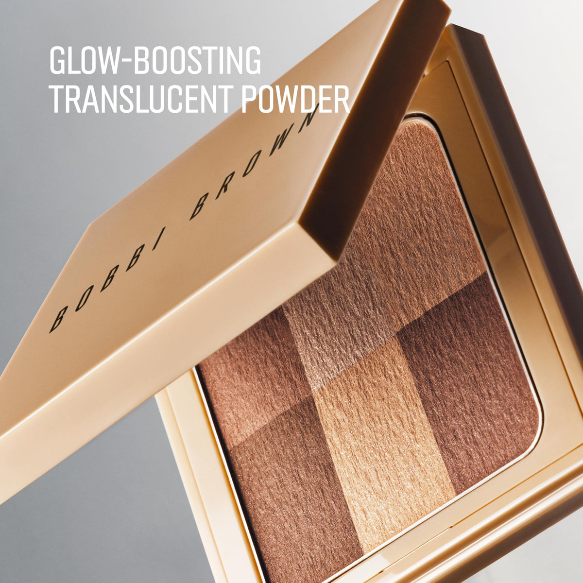 Bobbi Brown brush applying powder on cheekbone for subtle natural glow