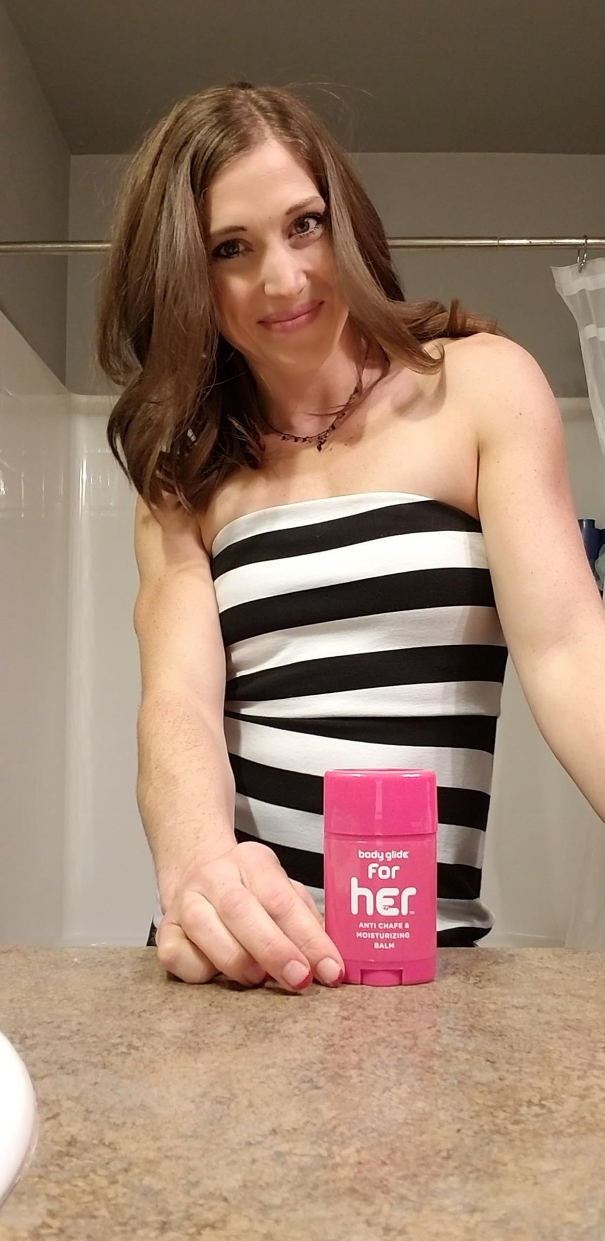 Applying BodyGlide to inner thighs to prevent rubbing during activity