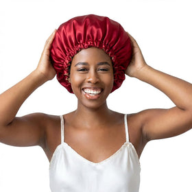 Bounce Curl bonnet held in hand to show compact size for travel convenience