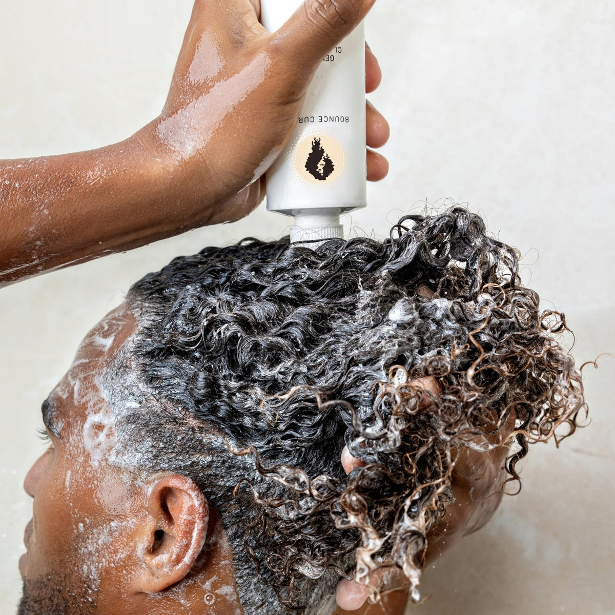 Bounce Curl shampoo in shower with lather showing in-use cleansing