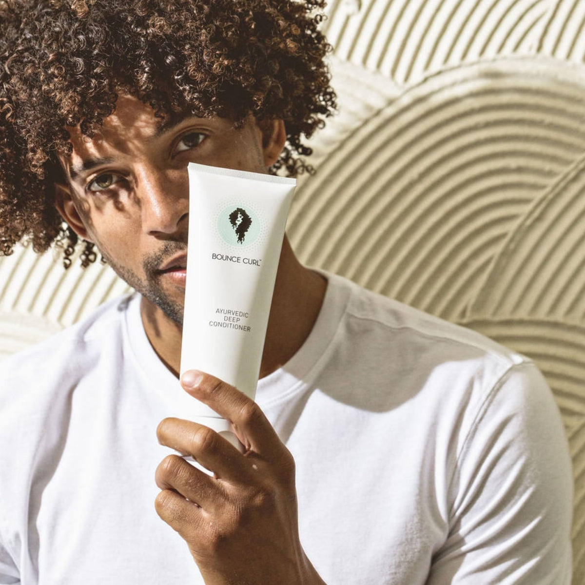 Bounce Curl peachy fruit image suggesting a light plant-derived fragrance benefit