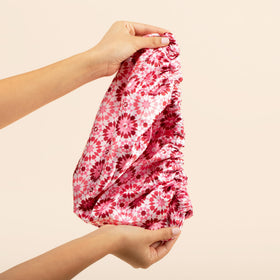 Bounce Curl bonnet size shown with hand for scale and coverage