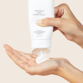 Bounce Curl 8 oz jar in hand showing scale and travel-friendly size benefit
