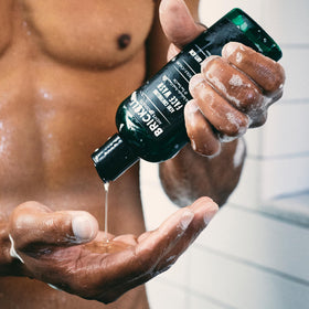 Brickell Men's Products foamy texture on hand highlighting gentle cleansing