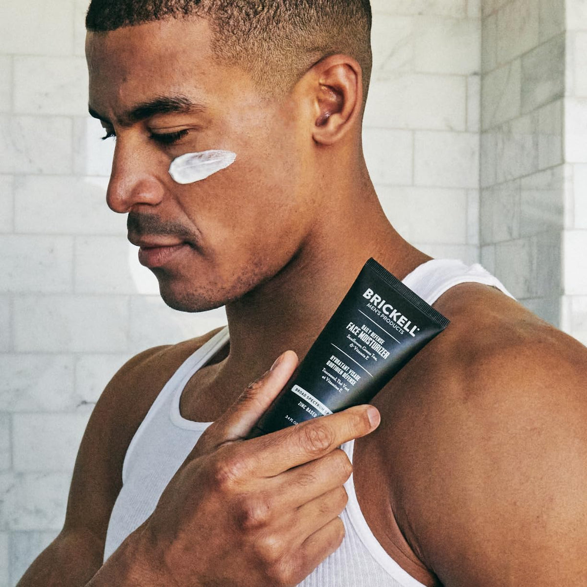 Brickell Men's Products being applied by man illustrating smooth coverage and non-greasy feel
