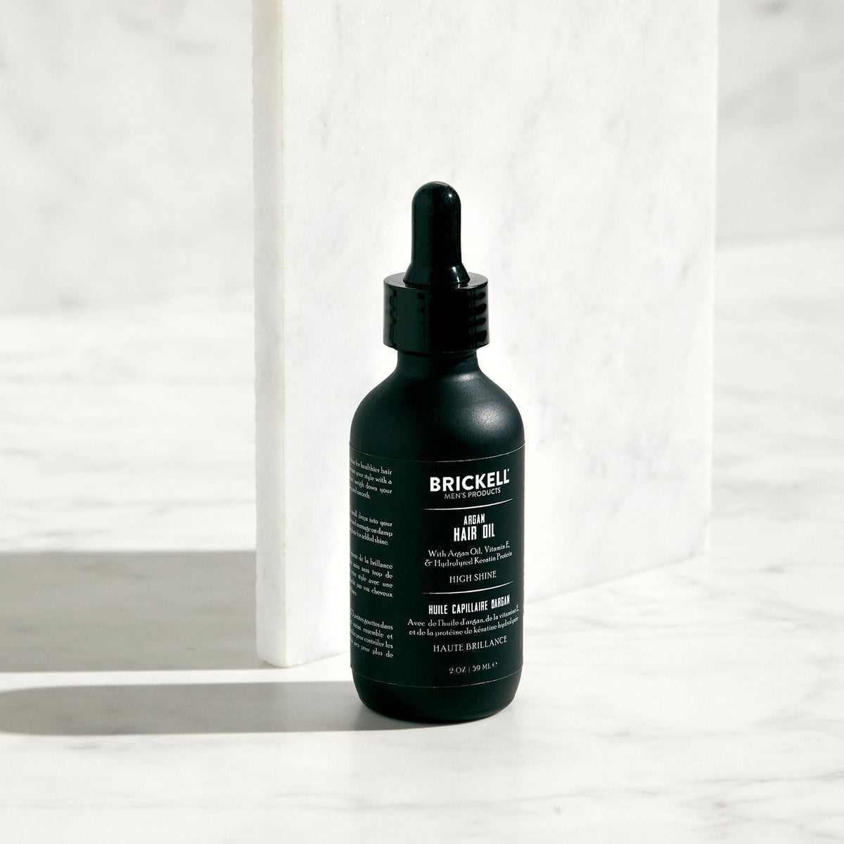 Brickell Men’s argan oil rubbed into hands demonstrating quick-absorb benefit