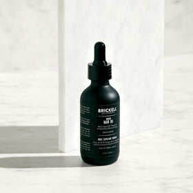 Brickell Men’s argan oil rubbed into hands demonstrating quick-absorb benefit