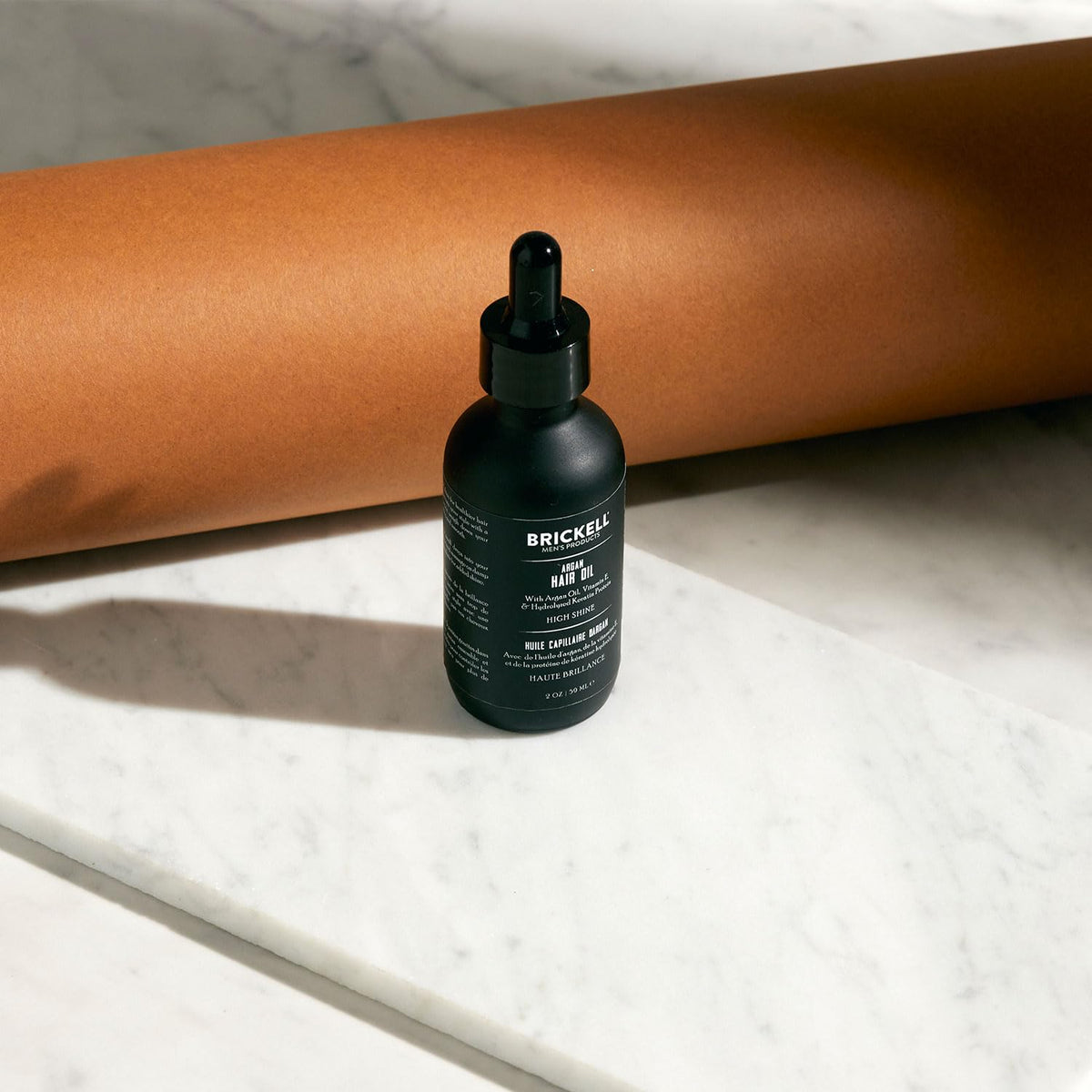 Brickell Men’s argan oil applied to hair smoothing frizz and adding shine