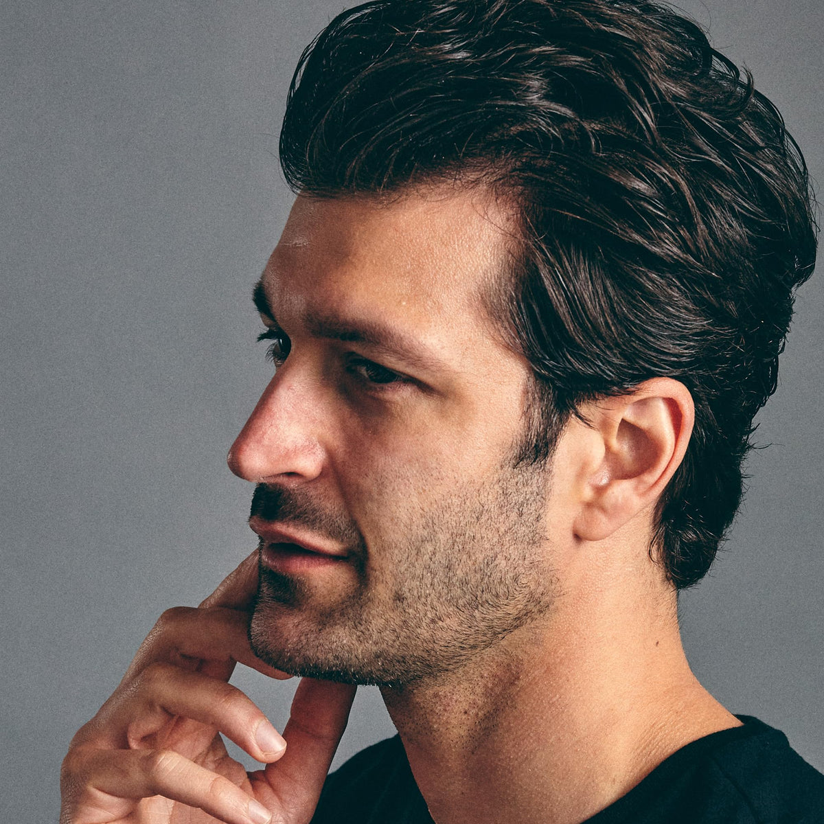 Brickell Men's Products being applied on hands and styled hair, demonstrating precise control benefit