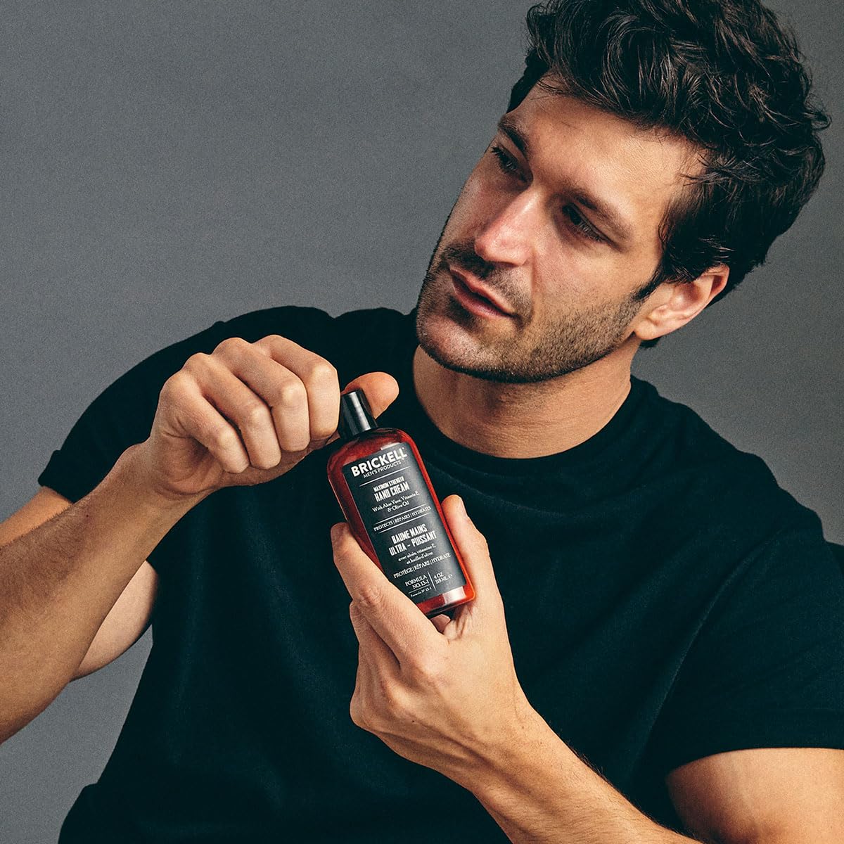 Brickell Men's Products hand application showing moisturized skin benefit