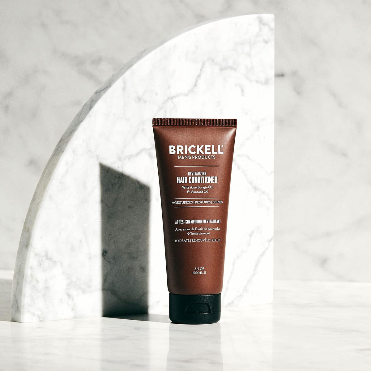 Brickell Men's creamy conditioner texture close-up demonstrating smooth spreadable formula for hydration