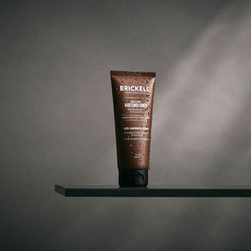 Brickell Men's conditioner in bathroom setting with towel, illustrating easy daily use and grooming routine benefits