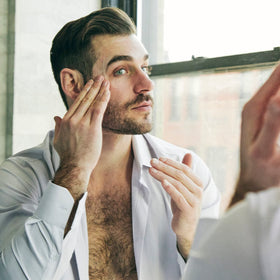 Brickell Men's Products kit beside grooming items showing compact travel convenience