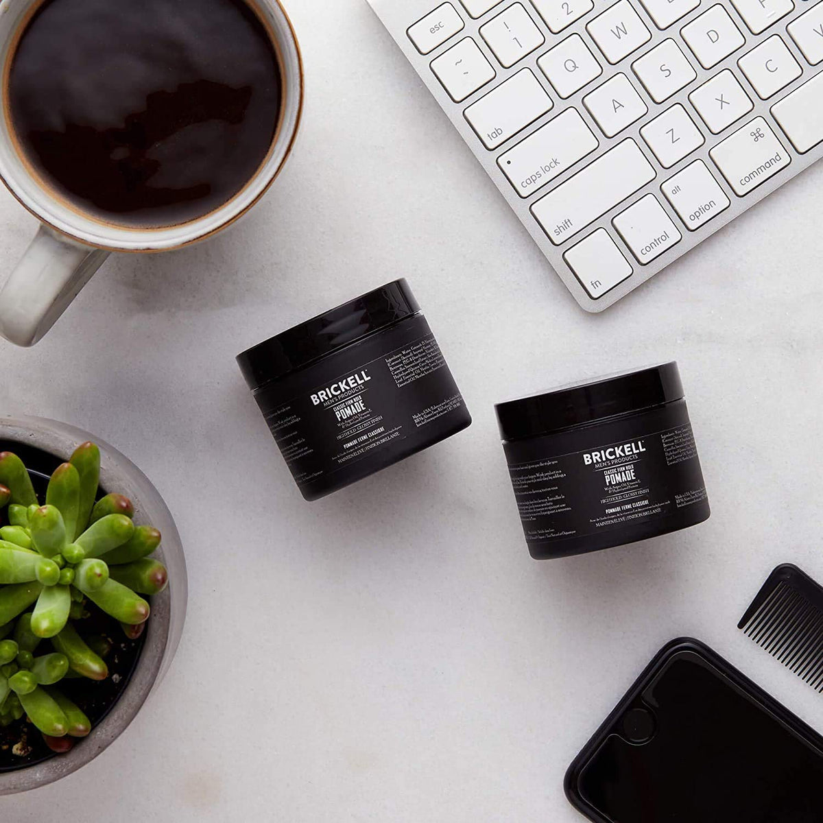 Brickell Men's Products applying pomade on fingers to demonstrate easy spreadability benefit