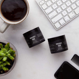 Brickell Men's Products applying pomade on fingers to demonstrate easy spreadability benefit