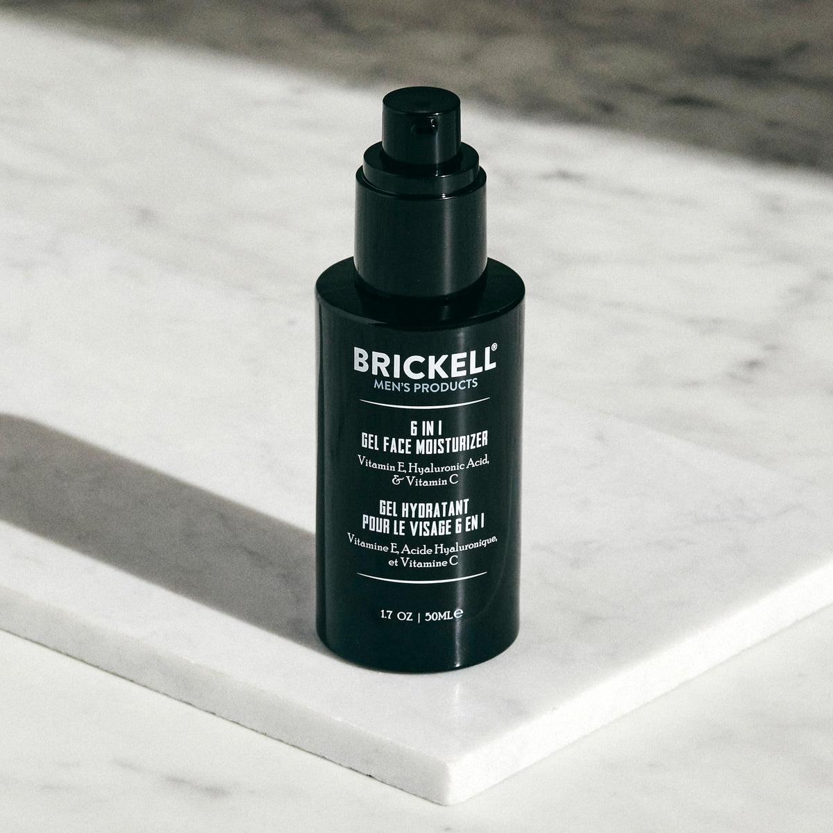 Brickell Men's Products 1.7 oz tube next to everyday items showing travel size
