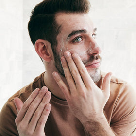 Brickell moisturizer in hand showing 2 ounce size and travel-ready benefit