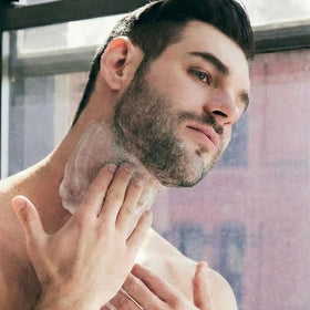 Brickell Men's Products applying cream to neck showing precise dispensing and control