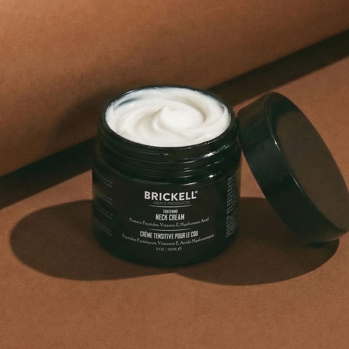 Brickell Men's Products next to a credit card to show the 2 ounce travel size